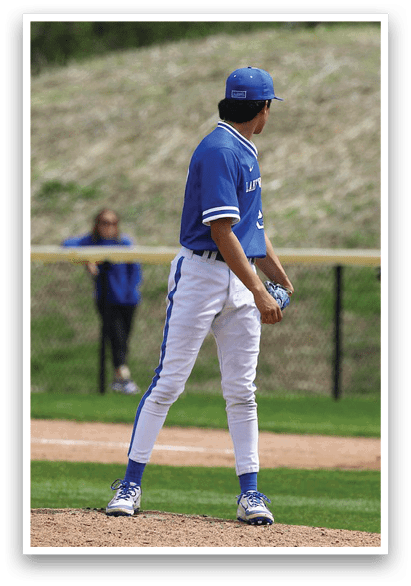 A baseball player in a blue and white uniform stands on the pitcher's mound, holding a baseball glove. AI generated content