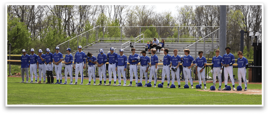 Baseball players in blue uniforms are lined up on the field, some of them holding baseball bats. AI generated content
