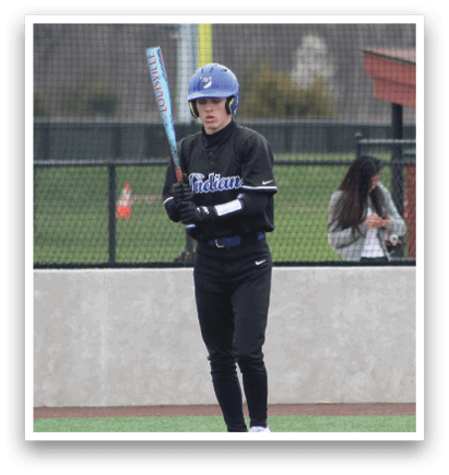 A baseball player wearing a blue helmet and black uniform stands on the field holding a bat. AI generated content