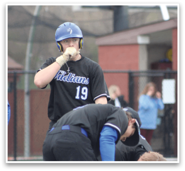 A baseball player wearing a blue helmet is kneeling down next to another player. AI generated content