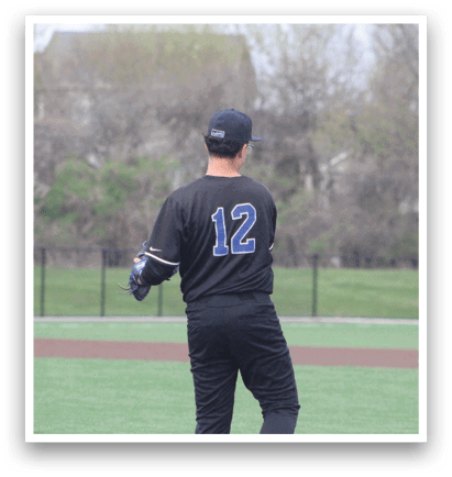A baseball player wearing a black jersey with the number 12 on it stands on a field. AI generated content