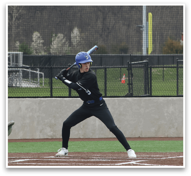 A baseball player in a black shirt and blue helmet is swinging a bat at a ball. AI generated content