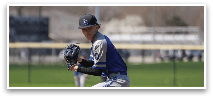 A baseball player in a blue and gray uniform is on the mound, getting ready to throw the ball. AI generated content