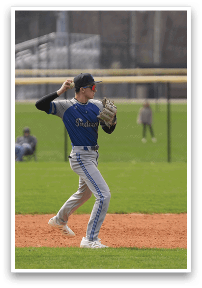 A baseball player in a blue shirt and white shoes is on the pitcher's mound, preparing to throw a ball. AI generated content