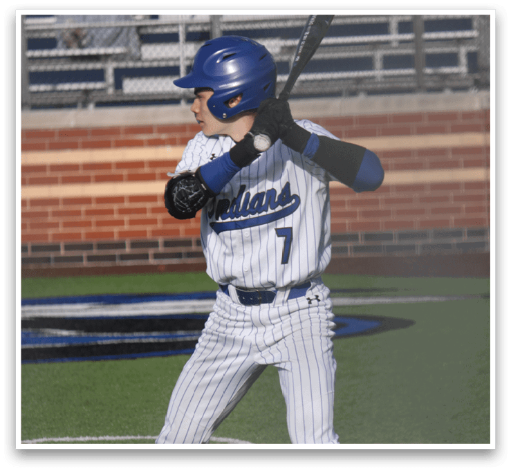 A baseball player in a white and blue uniform is swinging a bat, attempting to hit a ball. AI generated content