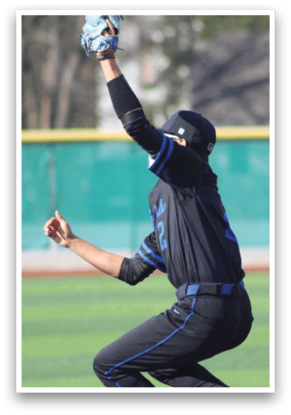 A baseball player wearing a black and blue uniform is catching a ball. AI generated content
