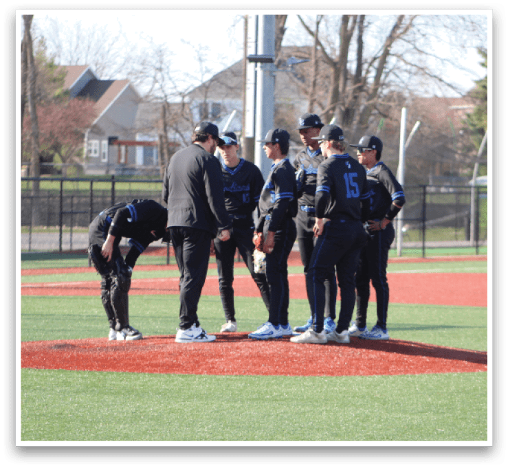 Baseball players wearing black and blue uniforms are gathered on the field. AI generated content