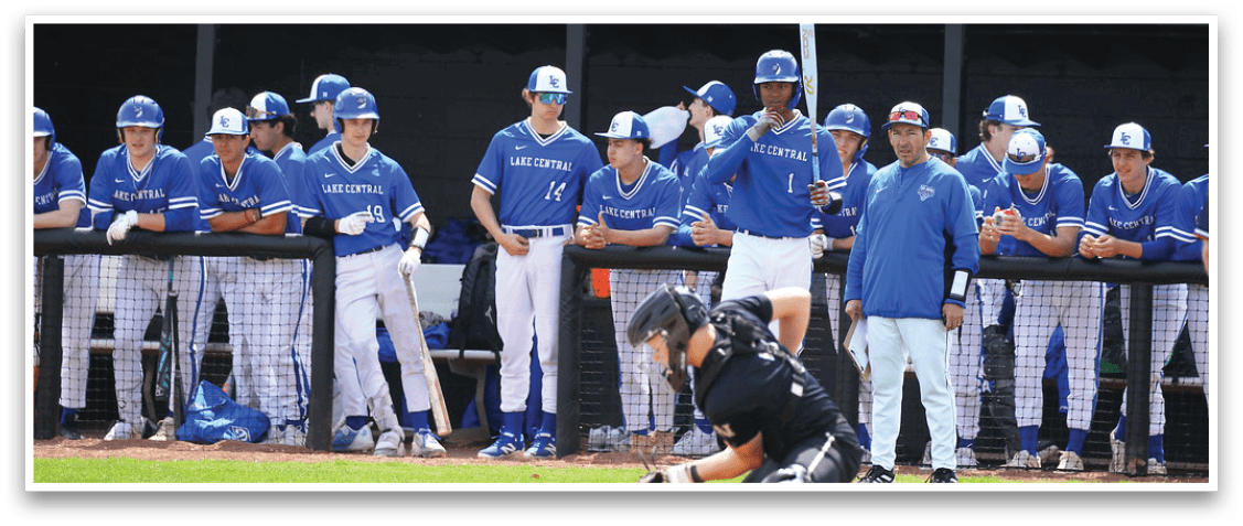 A baseball game is in progress with a batter at home plate holding a bat. The catcher is in position, ready to catch the ball. The umpire is also present, observing the play. The batter is wearing a blue shirt and a blue helmet. The catcher is wearing a baseball glove. The scene is set on a baseball field with a crowd of people watching the game. AI generated content