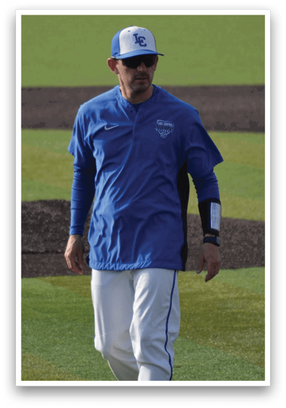 A baseball player wearing a blue jacket and white pants walks across a field. AI generated content