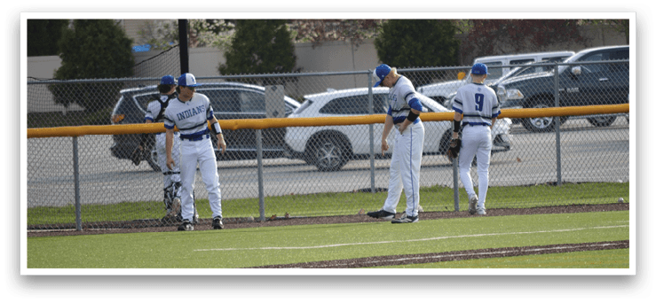 Three baseball players are standing on a field, wearing their uniforms. They are holding baseball gloves, preparing for a game. There are several cars parked in the background, and a truck is visible as well. AI generated content