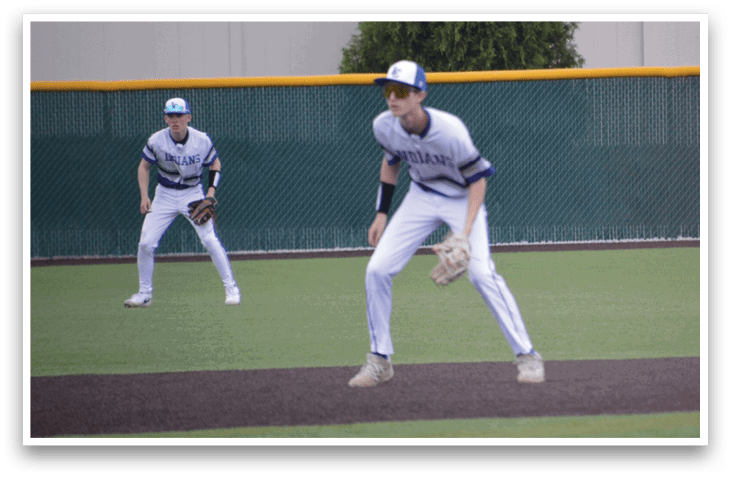 Two baseball players on a field, one wearing a blue hat and white uniform. AI generated content