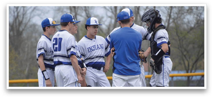 A group of baseball players wearing blue and white uniforms are standing on a field. AI generated content