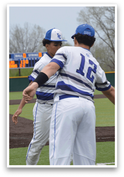 Two baseball players are hugging on the field, one wearing a blue and white uniform and the other wearing a blue and white and black uniform. AI generated content