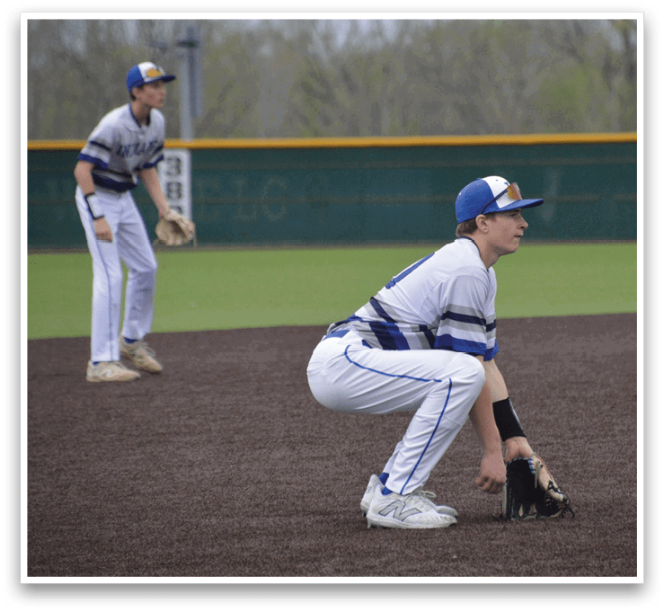 Two baseball players are on the field, one crouching down and the other standing. The crouching player is wearing a baseball glove. AI generated content