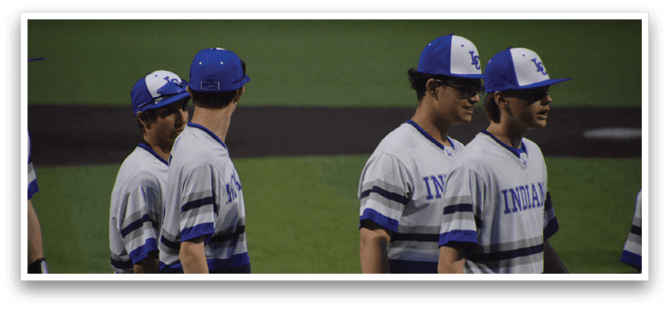 A group of baseball players wearing blue and white uniforms are walking on the field. AI generated content