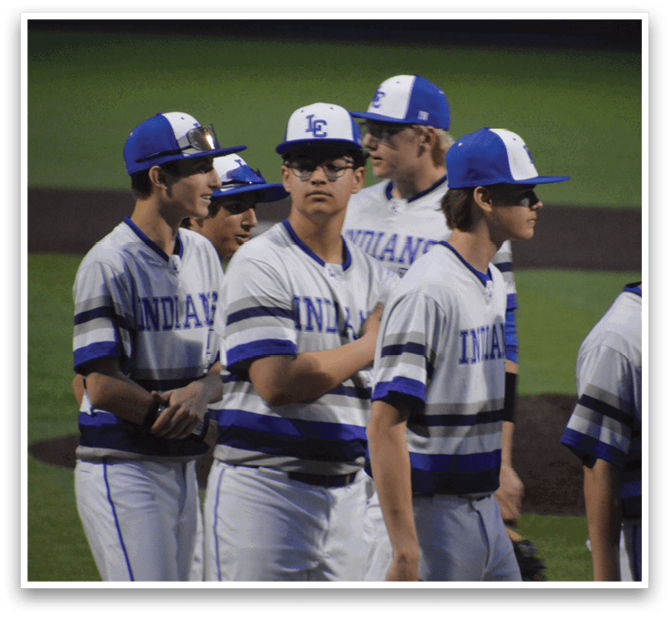 A group of baseball players wearing blue and white uniforms are standing on a field. AI generated content