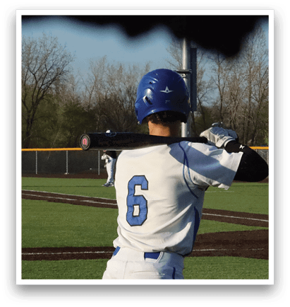 A baseball player in a white and blue uniform is holding a bat, getting ready to hit the ball. AI generated content