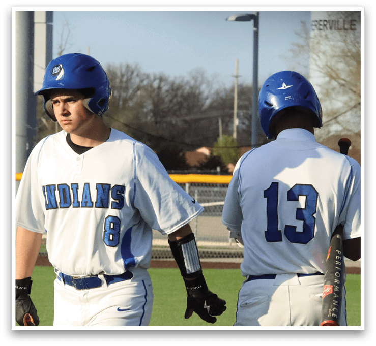 Two baseball players wearing blue helmets and white uniforms walk on the field. AI generated content
