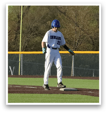 A baseball player in a white uniform stands on a field, holding a bat and getting ready to hit the ball. AI generated content