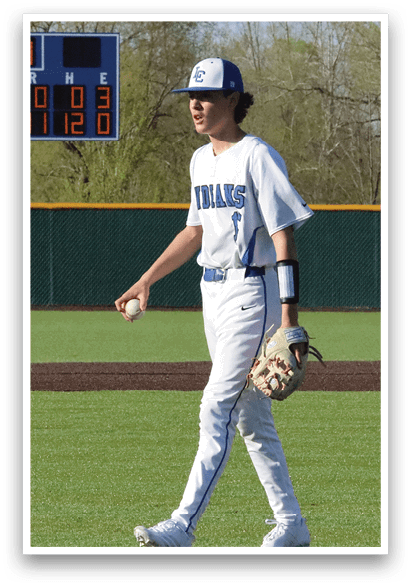 A baseball player wearing a blue and white uniform stands on the field holding a baseball. AI generated content