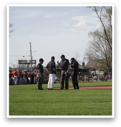A group of men are standing on a baseball field, engaged in a conversation. AI generated content