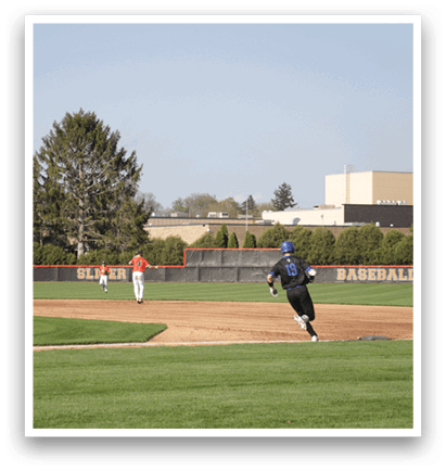 A baseball game is taking place on a field with players in uniforms. A man is running towards a base while another player is holding a baseball bat. AI generated content