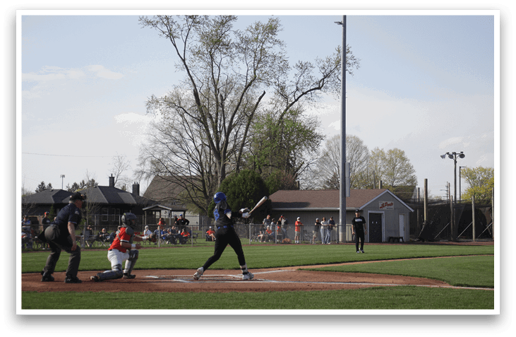 A baseball player is at bat, holding a bat and preparing to swing. The scene takes place in a baseball field with a crowd of people watching the game. AI generated content