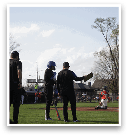 Three men are standing on a grassy field, engaged in conversation. One of the men is holding a baseball bat. AI generated content