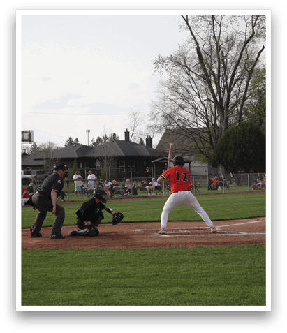 A baseball player is at bat, holding a bat and preparing to swing. The catcher and umpire are behind him, ready for the pitch. AI generated content