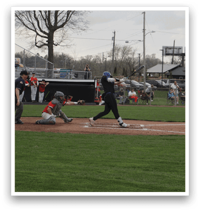 A baseball game is taking place with a batter at home plate, a catcher, and an umpire. The batter is holding a baseball bat and preparing to swing. There are several other people in the scene, some of whom are sitting on chairs and benches, watching the game. AI generated content