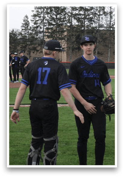 Two baseball players wearing black uniforms are standing on a field. AI generated content