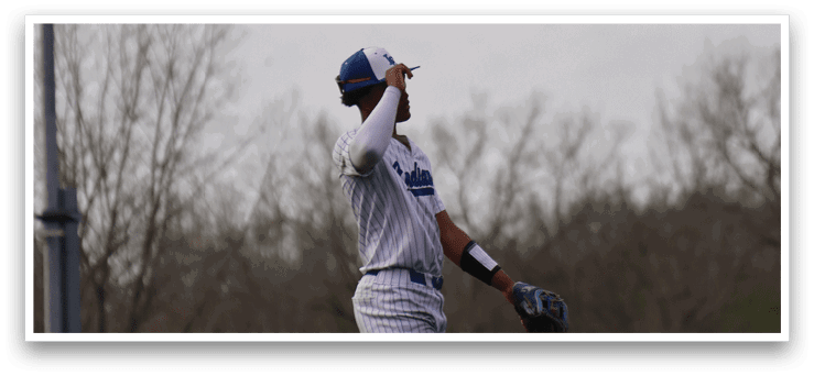 A baseball player in a blue and white uniform is running on the field, attempting to catch a ball. AI generated content
