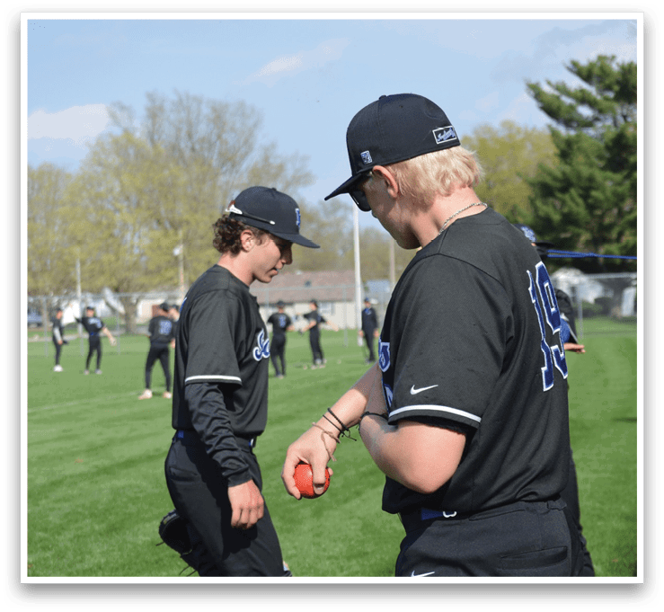 Two baseball players are standing on a field, one holding a red ball. AI generated content