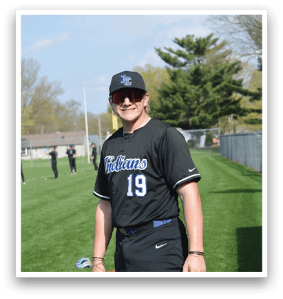 A man wearing a baseball uniform with the number 19 on the back stands on a grassy field. AI generated content