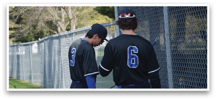 Two baseball players wearing black jerseys and blue hats are standing next to a fence. AI generated content
