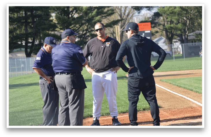 Three men in baseball uniforms are standing on a baseball field, talking to an umpire. AI generated content