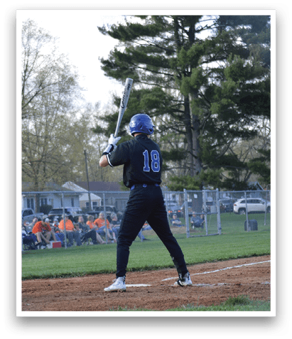 A baseball player in a black shirt and blue helmet is up to bat, holding a baseball bat and preparing to swing. AI generated content