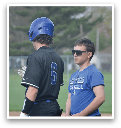 Two people are standing on a baseball field. One person is holding a bat, and the other is wearing a baseball helmet. AI generated content