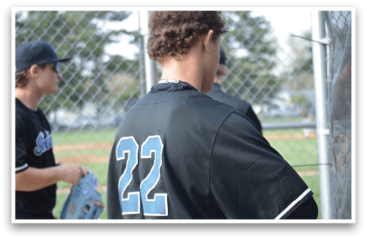 A baseball player wearing a black jersey with the number 22 on the back. AI generated content