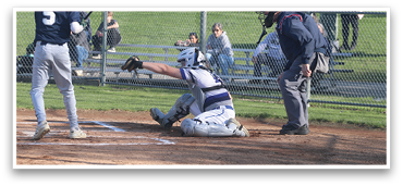 A baseball player is at bat, holding a bat and preparing to swing. The catcher is in position, wearing a baseball glove, ready to catch the ball. The umpire is also present, observing the play. There are several other people in the scene, some of whom are sitting on a bench. AI generated content