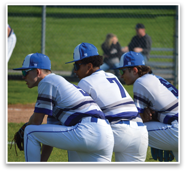 Three baseball players wearing blue and white uniforms are kneeling on the field. AI generated content