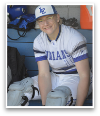 A baseball player wearing a white uniform and blue hat is sitting on a bench. AI generated content