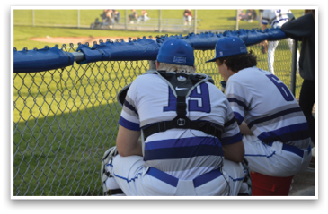 Two baseball players wearing blue and white uniforms sit on a bench. AI generated content
