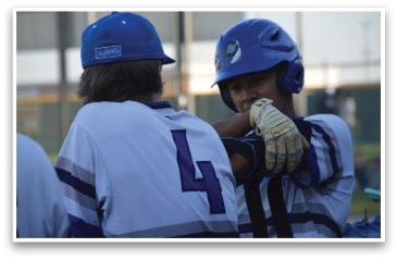 Two baseball players wearing blue helmets and white uniforms are talking to each other. AI generated content