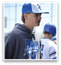 A group of people are standing outside a baseball field. A man wearing a blue and white hat is standing in front of a group of people, some of whom are wearing baseball gloves. AI generated content