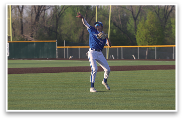 A baseball player wearing a blue shirt and white pants is jumping in the air to catch a ball. AI generated content