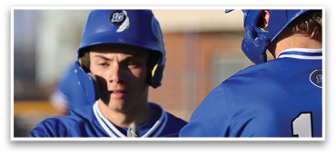 Two baseball players wearing blue uniforms and helmets are talking to each other. AI generated content