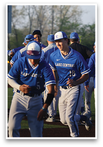 A group of baseball players in blue uniforms are walking on a field. AI generated content