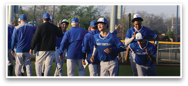 A group of baseball players wearing blue uniforms are walking on a field. AI generated content