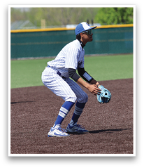 A baseball player in a blue and white uniform is crouching on the field, holding a baseball glove. AI generated content